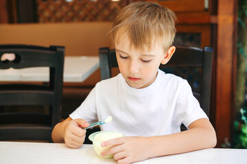 Cute kid eating favorite icecream. Happy childhood. Summer holidays. Childrens day.