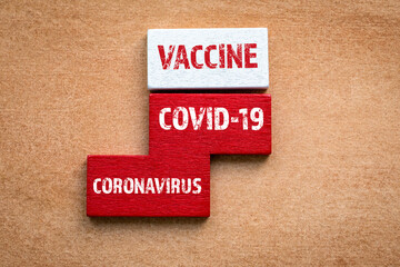 VACCINE and COVID-19 CORONAVIRUS concept. Colored wooden blocks, puzzle and mind game