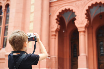 Boy with a digital camera taking pictures. School project for kids. Future profession.