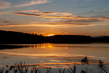 sunset over a forest lake