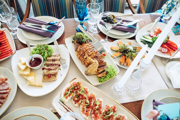 Festive dinner. A table with a variety of delicious food in the restaurant