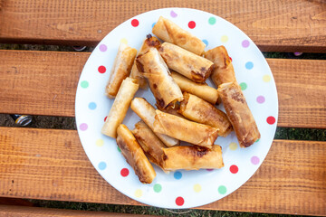 'Spring rolls on a spotty plate.