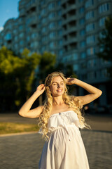 Portrait of a pregnant woman in city street