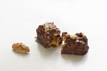 Close up cut chocolate with walnut filling on the white background
