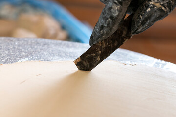 cut clay with a clerical knife, close-up
