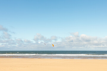 South Shields beach (South Promenade) on summer day with kite boarders at sea