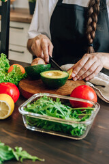 Woman cooking healthy food - vegetable salad. Dieting Concept. Healthy Lifestyle. Cooking At Home. Prepare Food