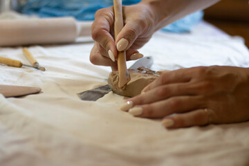 Obraz premium master ceramist works on clay parts, workflow