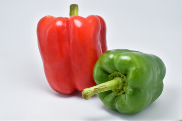 Red and green bell pepper isolated on a gray