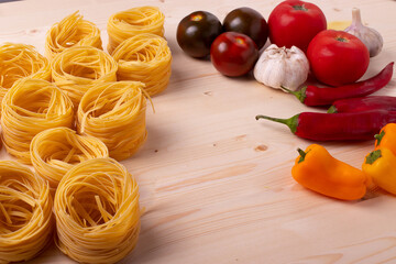 dry pasta rolls and ingrediets for making a tomato sauce