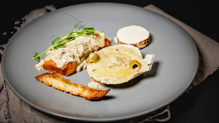 Close-up baked scallop on a shell with cheese and creamy sauce. Cooking at home using recipes restaurant. Seafood