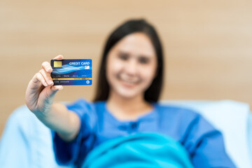 Young Asian woman patient holding mock up health credit card, Health Insurance concept