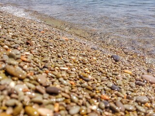 The pebble beach of Gurzuf. Transparent clear sea.