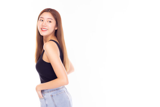 Portrait young Asian beauty woman , Charming girl look at copy space with smile face. Attractive beautiful female wear jeans, tank top in summer time. Gorgeous girl has long hair with brown hair dye