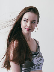 Fototapeta premium Beautiful brunette woman girl with long hair smooth and beauty in silver wear