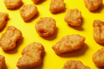 Flat lay with fried chicken nuggets on yellow background