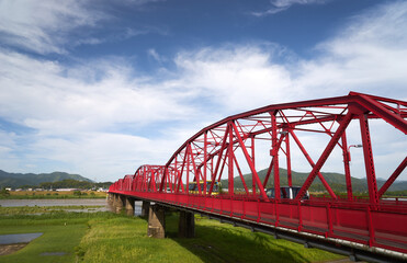四万十川に架かる赤いトラス橋と青空