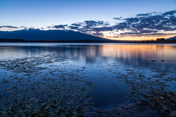 Fototapeta premium Beautiful long exposhure sunset landscape . The small lake and. beautiful panoramic viwe on the mountais after sunset. 