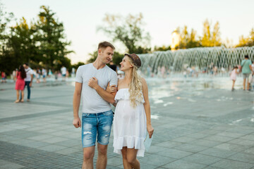 couple in the city square with fountains
