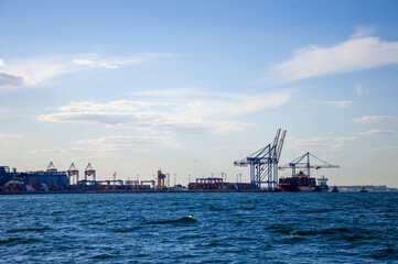 Fototapeta na wymiar Odessa port. Loading cranes at the port. View from the sea to the port.
