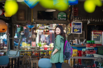 Beautiful asian women use smartphone listen music in art cafe