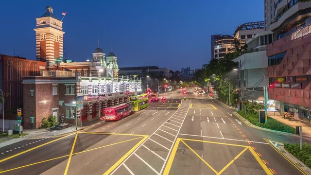 Street traffic near the fire station of Singapore night to day transition aerial timelapse. The Central Fire Station is the oldest existing fire station in Singapore on Hill street