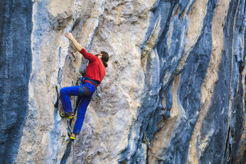 A strong man climbs a rock, Rock climbing in Turkey.