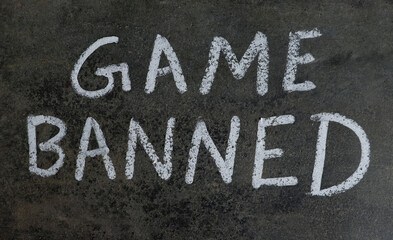 Game Banned Phrase Written on Blackboard with White Chalk