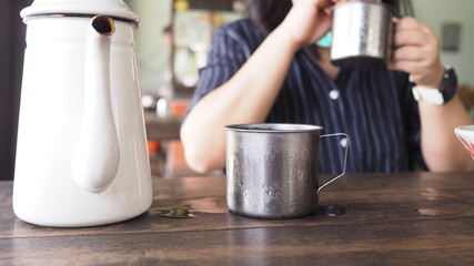 Woman who wear facial mask is handing ice cup in food shop