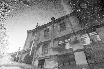 Puddle reflection of vintage house