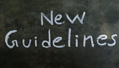 Obraz premium New Guidelines Phrase Written On Blackboard With White Chalk