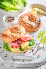 Homemade bagel with cheese and ham for fresh breakfast