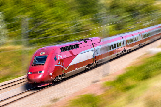Ver-sur-Launette, France - July 29, 2020: A Thalys high speed train is driving at full speed in the french countryside (artist's impression).