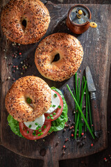 Homemade bagel with mozzarella, tomatoes and lettuce