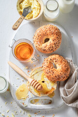 Fresh bagel with honey and butter in the morning