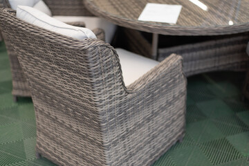 A wicker gray conference chair stands near the table