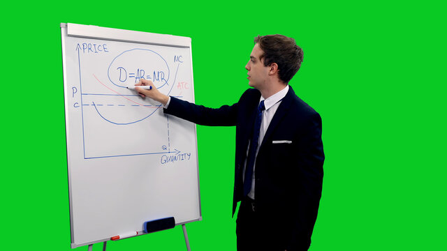 Young business coach in suit explaining production function on white board during financial team meeting against green screen background, chroma key 