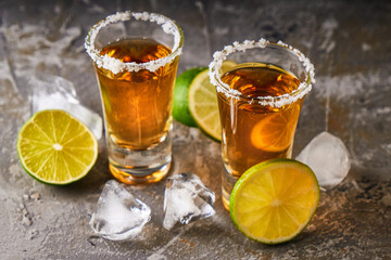 Appetizing tequila with lime and salt in a glass with ice