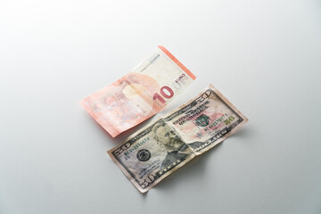 Paper banknotes of the countries of the world on light table. Euro and dollars on isolated background