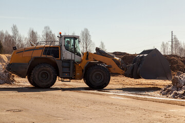 yellow industrial bulldozer at sawmill