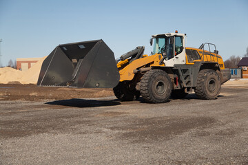 Obraz na płótnie Canvas yellow industrial bulldozer at sawmill