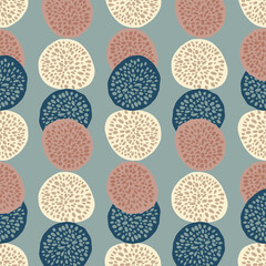 Simple seamless pattern with dotted circle ornament. Pastel blue background with navy, coral and light elements.