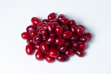 Dogwood on a white background. Fresh red dogwood lies in a small heap. Gathering the summer harvest.