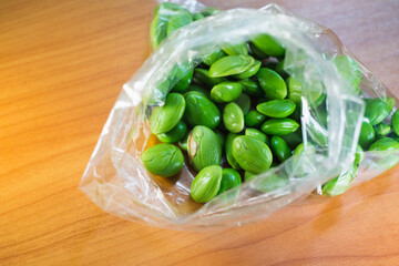 Closeup fresh Sato in plastic bag, Thai bitter bean the important ingredient of Thailand famous...