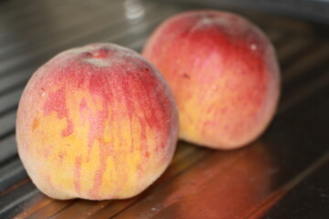 ripe peaches on a metallic silver background