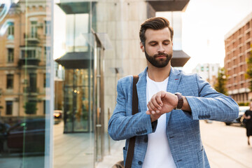 Young attractive man looking at his watch