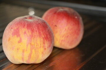 ripe peaches on a metallic silver background