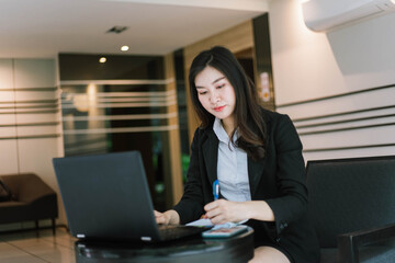 asian business woman using laptop computer in office