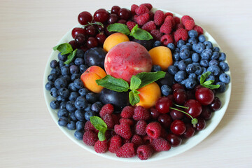 Berry mix on a plate on a white background.Texture or background