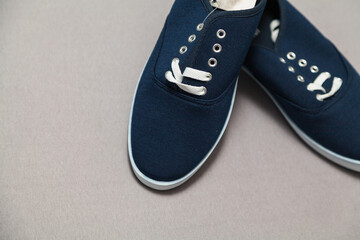 Pair of blue sneakers standing on a white background